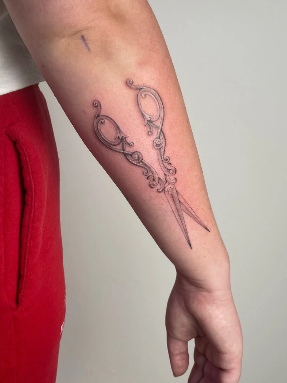 scissors fine line tattoo on forearm