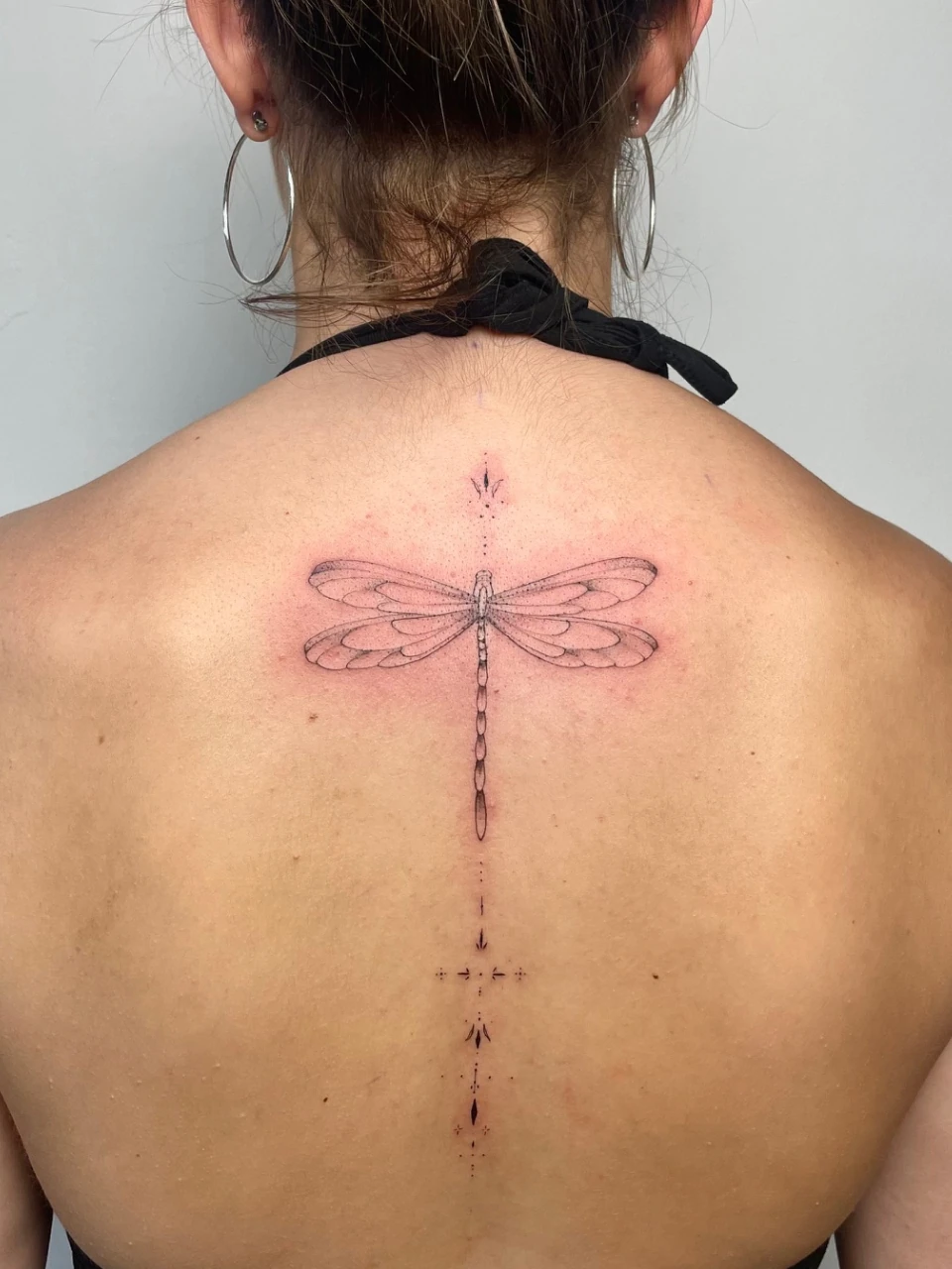 butterfly fine line tattoo on the back