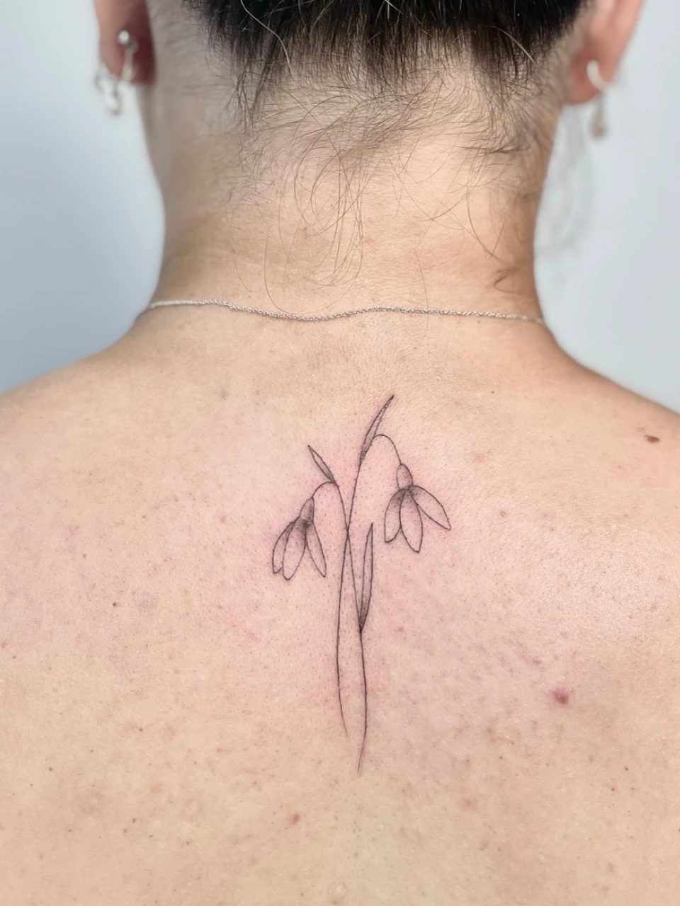 snowdrops fine line tattoo on the back