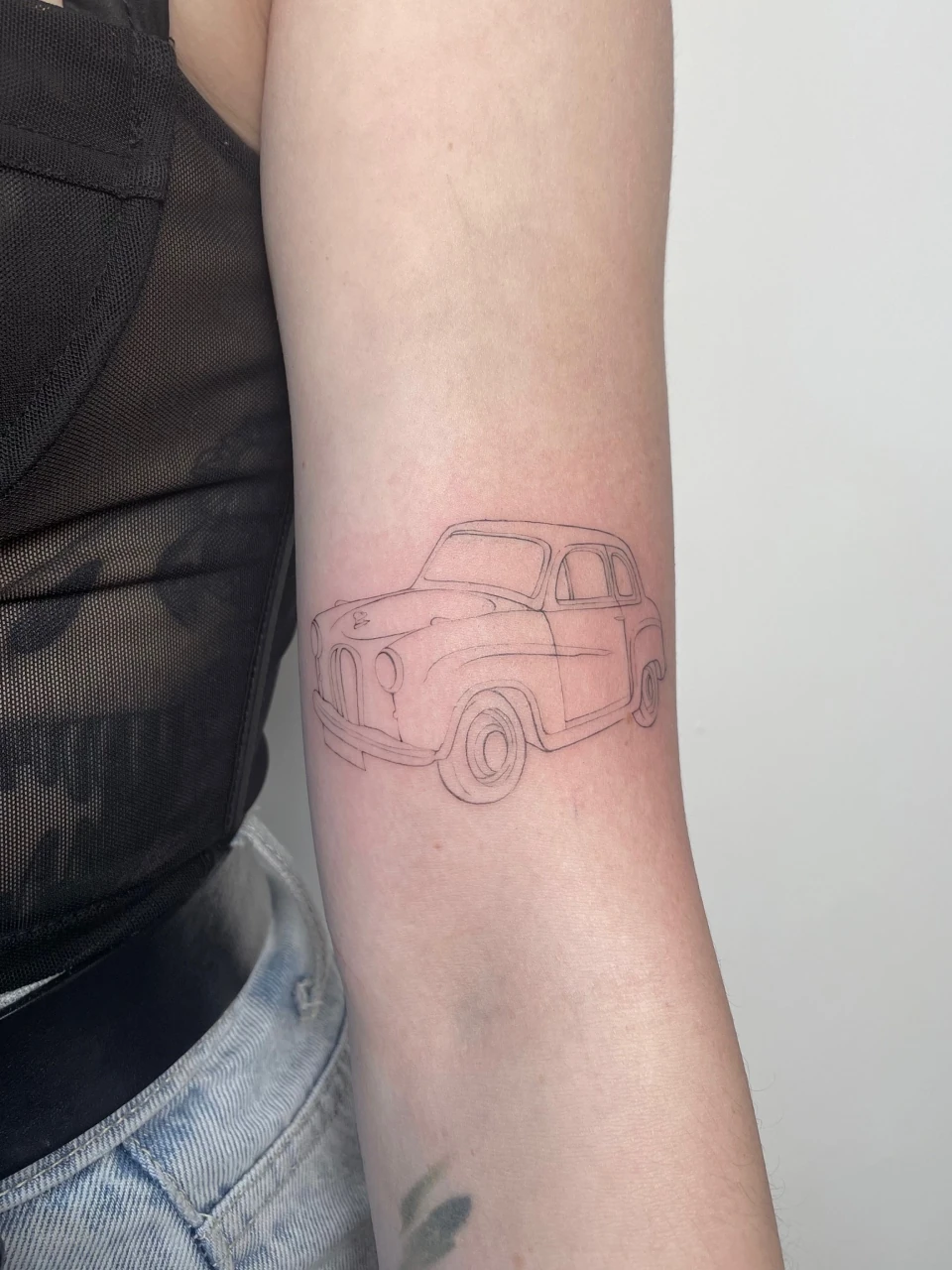 car fine line tattoo on arm