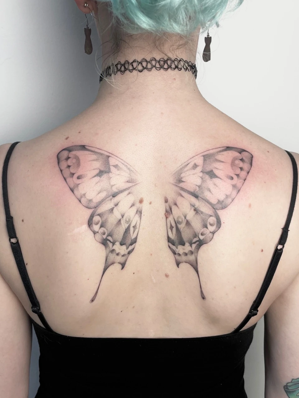 butterfly fine line tattoo on the back