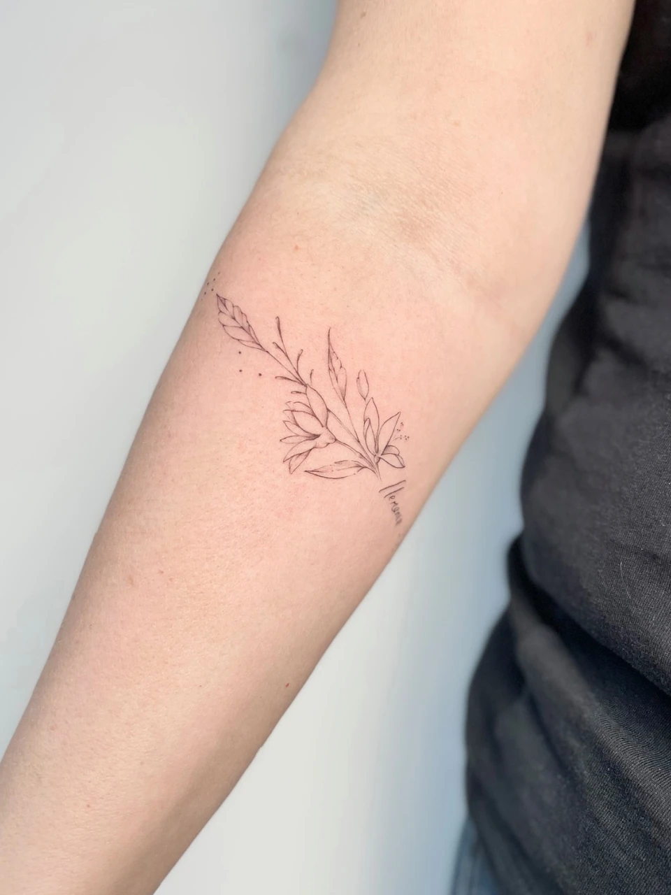 floral bracelet fine line tattoo on forearm